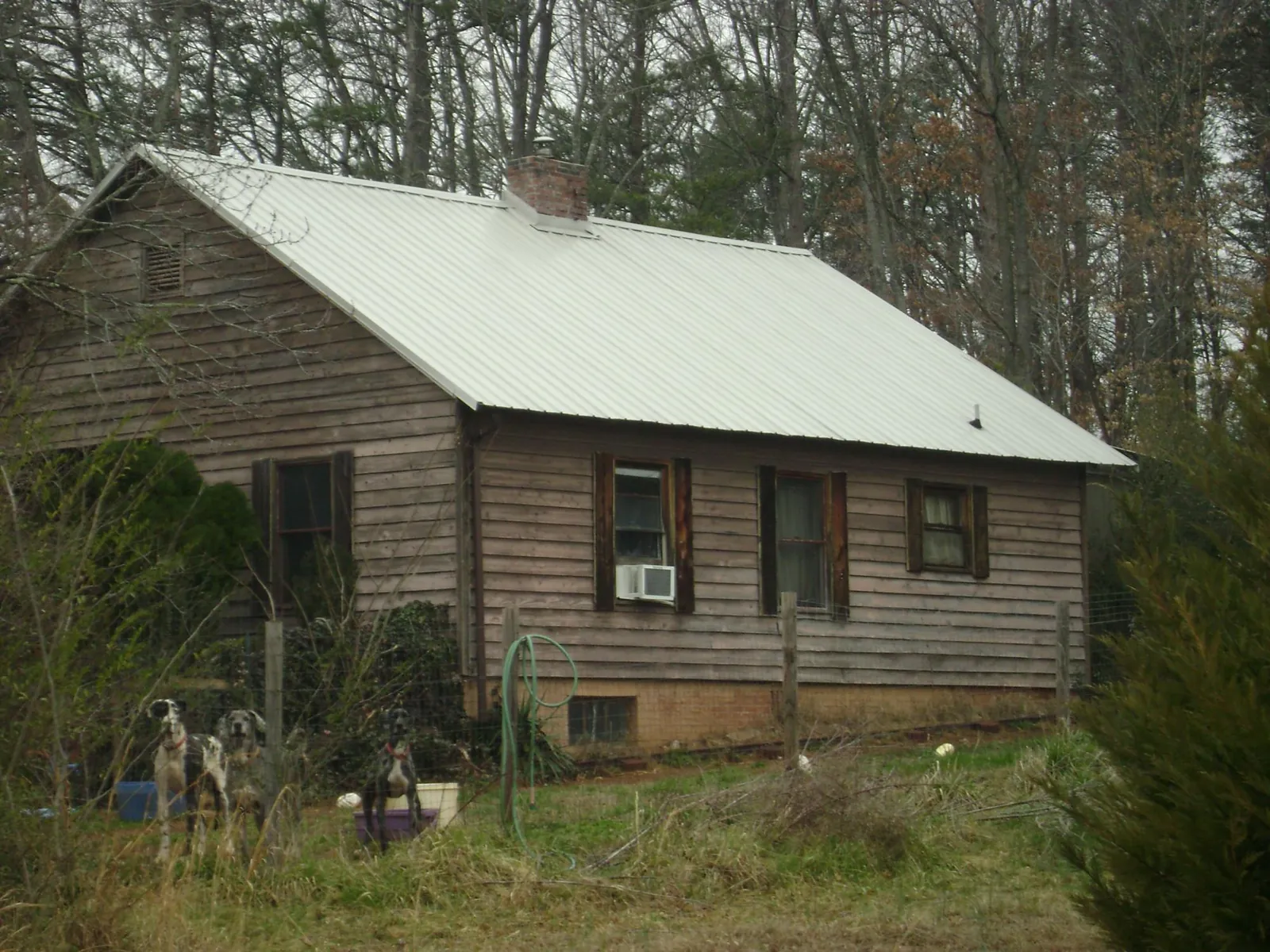 White metal roof on an old wood sided farmhouse, from a Metal Roof Installation job in Brainard